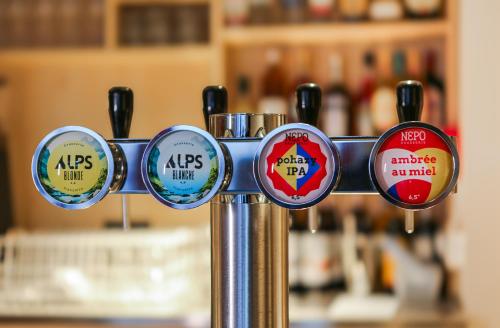 a bunch of different stickers on a metal pole at Mustard Hostel in Dijon