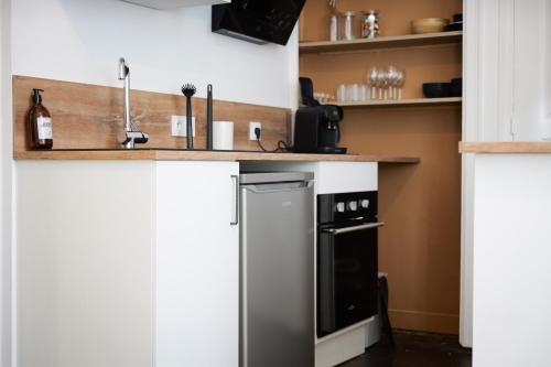 a kitchen with a stainless steel refrigerator and a counter at bel appartement 2-4 personnes coeur de ville Angers in Angers