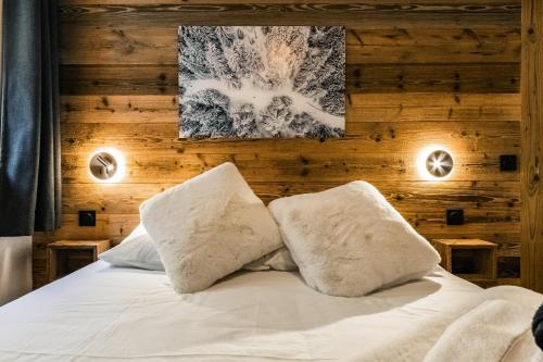 a bedroom with a bed with two pillows at Centre Les Gets with 2 parking and Slope views - 6&2 ppl - Asteria in Les Gets
