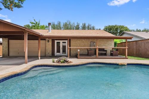 a house with a swimming pool in front of a house at May Specials - Private Pool, Family Friendly! in The Colony