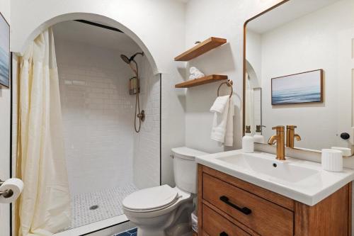 a bathroom with a sink and a toilet and a shower at May Specials - Private Pool, Family Friendly! in The Colony