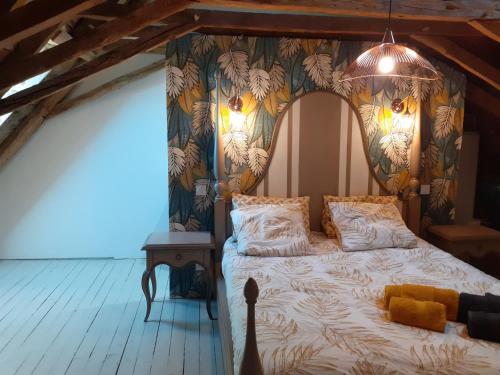 a bedroom with a bed with a canopy at GITE DE L'AUTAN - Villa 8 pers-4 salles de bain indépendantes, piscine chauffée et Spa in Durenque