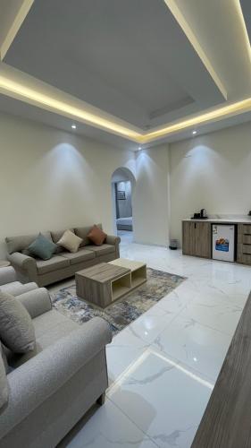 a living room with a couch and a coffee table at شقق واڤا in Tabuk