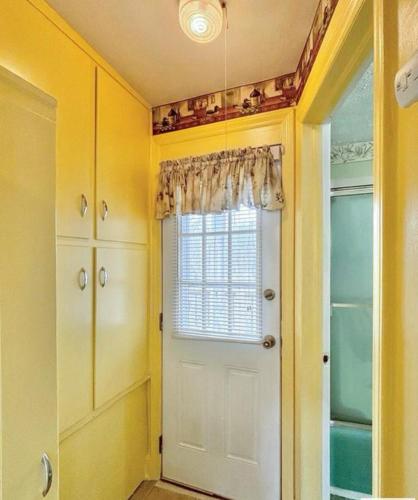 a room with a white door and a window at The Honey Home in Martinsville