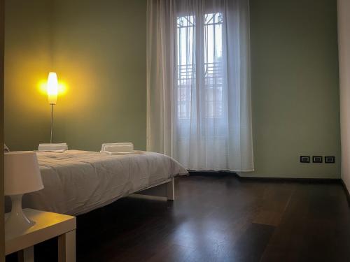 Ένα ή περισσότερα κρεβάτια σε δωμάτιο στο Casa Adelaide Rho Fiera