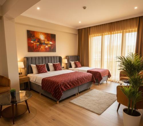 a hotel room with two beds and a couch at Trabzon Live Hotel in Bostancı