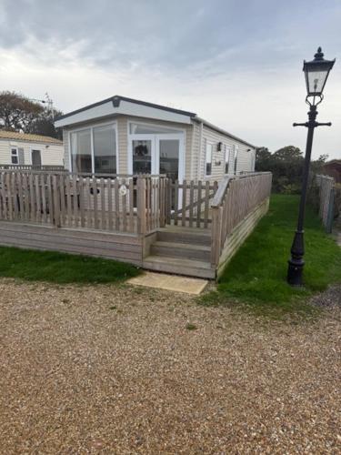 a house with a porch and a street light at Hurst View Caravan Park in Lymington