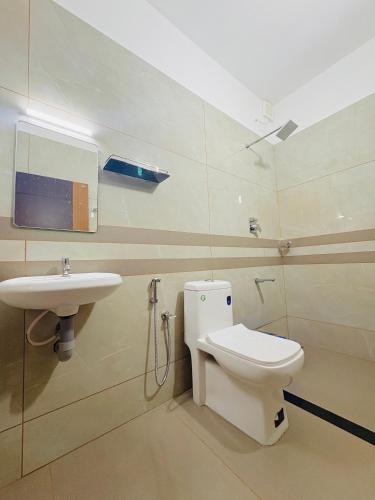 a bathroom with a toilet and a sink at Ann Villa homestay in Anachal