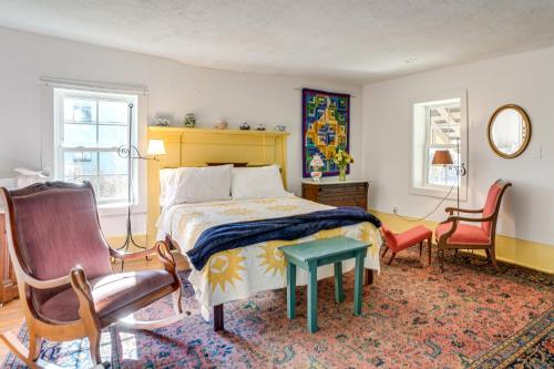 a bedroom with a bed and two chairs and a table at Blue Ridge Retreat! Cottage on the Rapidan River in Locust Dale
