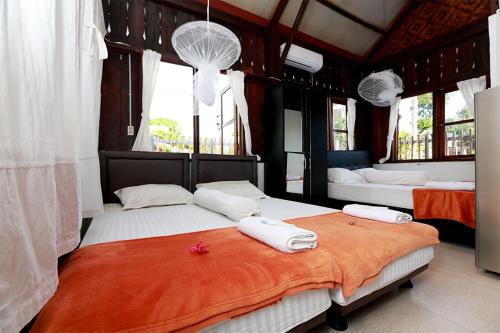 a bedroom with two beds with white pillows at Arya's Surf Camp Cimaja in Sukabumi