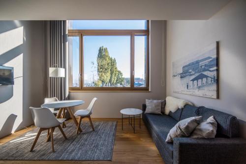 a living room with a couch and a table at LAKE-LOFT APARTMENT's direkt im Hafen in Romanshorn