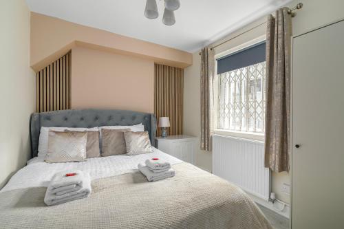 a bedroom with a bed with two towels on it at Stylish Flat near Regent's Park in London