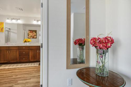 a vase of flowers on a table in a bathroom at Relaxing Vegas Stay with BBQ & Games in Las Vegas