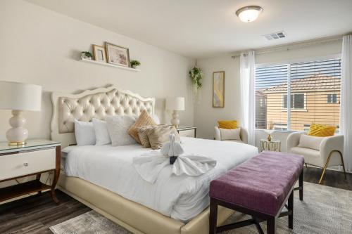 a bedroom with a large white bed and a chair at Relaxing Vegas Stay with BBQ & Games in Las Vegas