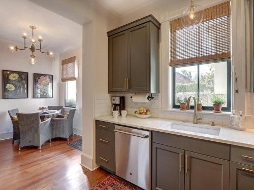 a kitchen with a sink and a dishwasher at Luxury on Lincoln in Savannah