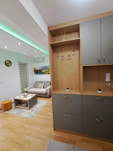 a living room with a large cabinet and a couch at Tiha noć II Vrnjačka Banja in Vrnjačka Banja