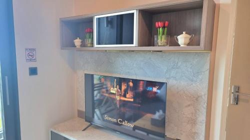 a flat screen tv sitting inside of a fireplace at Silk Ao Nang Condominium in Ao Nang Beach