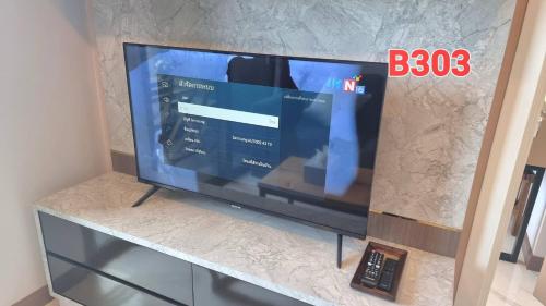a flat screen tv sitting on top of a counter at Silk Ao Nang Condominium in Ao Nang Beach