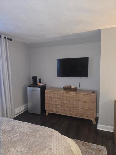 a bedroom with a flat screen tv on a wall at Cozy Room in Revere near Beachmont Blue Line Station in Revere