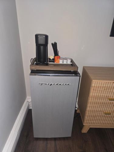a small cabinet with a coffee pot on top of it at Cozy Room in Revere near Beachmont Blue Line Station in Revere