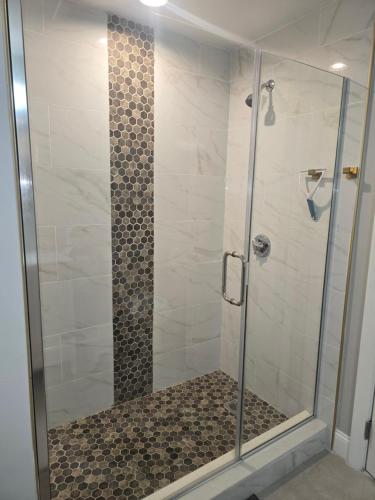 a walk in shower with a glass door at Cozy Room in Revere near Beachmont Blue Line Station in Boston