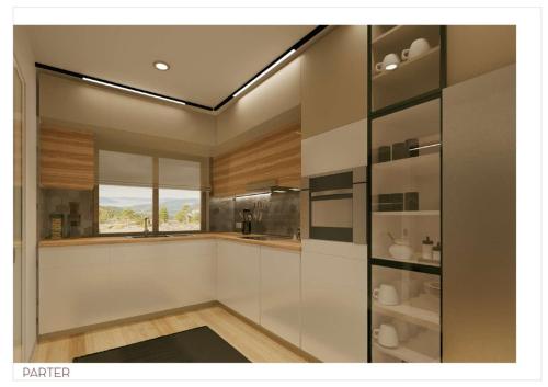 una cucina con mobili bianchi e una finestra di Villa Prestige Collection a Scheia