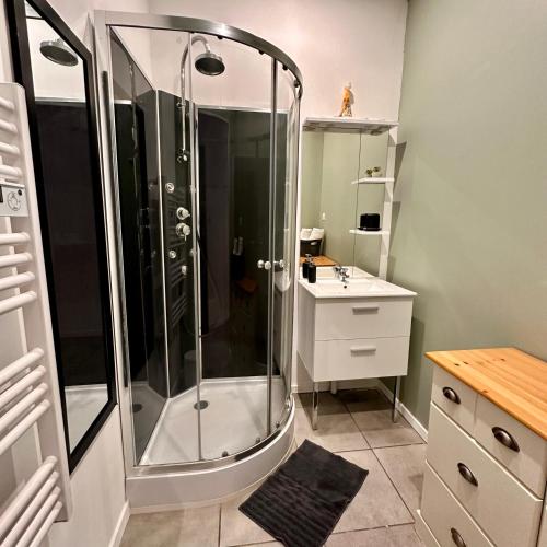 a bathroom with a shower and a sink at 110 - Green Forest in Lewarde