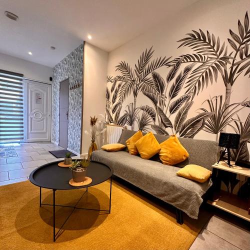 a living room with a couch and a table at 110 - Green Forest in Lewarde