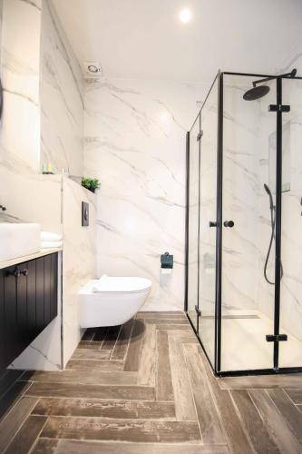 a bathroom with a shower and a toilet and sink at Caesarea :In the front of the sea in Caesarea