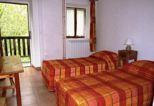 a hotel room with two beds and a balcony at Refuge d'hiver de N&M in Tende
