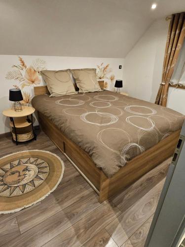 a large bed in a bedroom with two lamps at Gîte Vallée de Munster 3 étoiles chez Flavie & Ludo in Muhlbach-sur-Munster