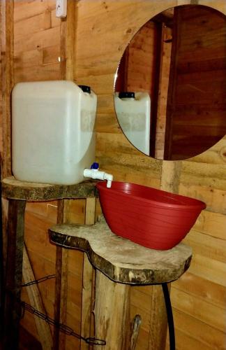 a bathroom with a mirror and a red bowl at Manglar Eco Resort in La Barra