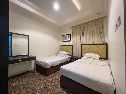 Ένα ή περισσότερα κρεβάτια σε δωμάτιο στο Malfa SERVICED APARTMENTS