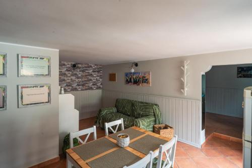 a living room with a table and a couch at Ciauru ri Casa in Mascalucia