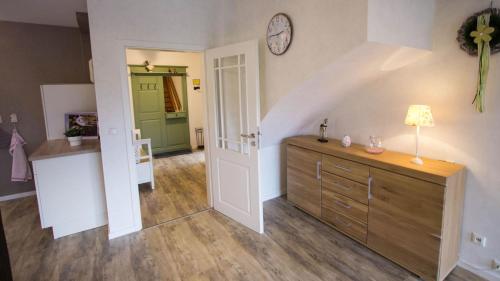 a room with a hallway with a clock on the wall at Fewo am Iberg 20, inkl Parkplatz in Willingen