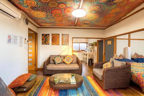 a living room with a painting on the ceiling at Noa ペットOKの一軒家貸切 in Shiraoi