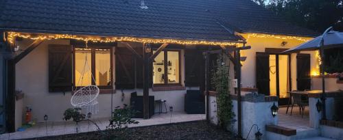 a house with lights on the front of it at Le Cottage de Maé in Seigy