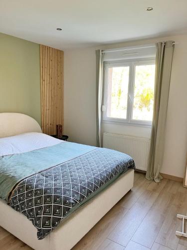 a bedroom with a bed and a window at House with Outdoor Jacuzzi in Rocroi