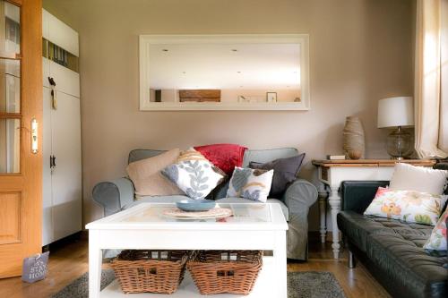 a living room with a couch and a table at Apartamento Reina de la Paz en San Sebastián de Garabandal in RIonansa