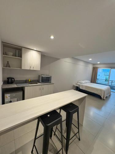 a kitchen with a table and a bed in a room at Otero Coliving - Studio Entero U4 in San Salvador de Jujuy