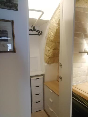 a room with a closet with a desk and a door at Le Antiche Travi in Bari