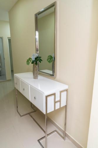 a white dressing table with a mirror on a wall at La Isla Royal - Raya Cosmica in Miches