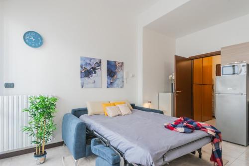 a bedroom with a bed and a refrigerator at La Villa Strangiato in Seregno