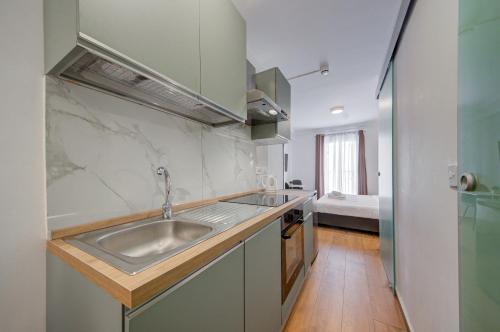 a kitchen with a sink and a counter top at Tritoni Alta suites in Il-Gżira