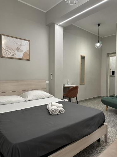 a bedroom with a large bed and a chair at Charm Airport in Reggio di Calabria
