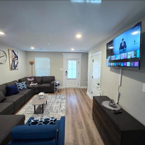 a living room with a couch and a flat screen tv at Coastal Oasis on Biloxi Beach - Gulf Coast Vac Home in Biloxi