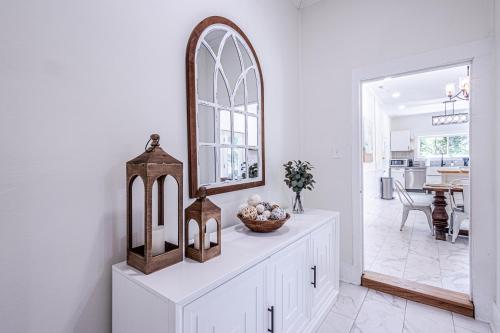 a mirror on top of a white dresser in a room at Steps to Bryson, walk anywhere downtown! in Bryson City