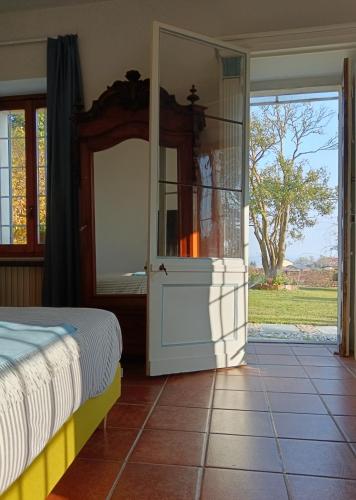 a bedroom with a bed and a sliding glass door at BotanicaSuiteTorino in Baldissero Torinese