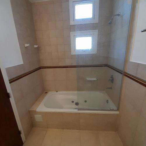 a bath tub in a bathroom with a window at Manzana 1 in Mar de las Pampas