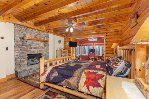 a bedroom with a bed and a stone fireplace at Oakland Bear Lair in Oakland